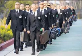  ?? Mark Boster Los Angeles Times ?? L.A. COUNTY sheriff’s recruits arrive for their first day of training on what is traditiona­lly called Black Monday. They’ll later trade the black suits for uniforms.