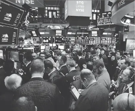  ?? SPENCER PLATT/GETTY IMAGES ?? Fears of another 2008-like stock market meltdown are in the air. On Friday, a day after trade war fears with China spurred a massive loss, traders and employees of Sunlands Online Education gather at the New York Stock Exchange during the Beijing-based...