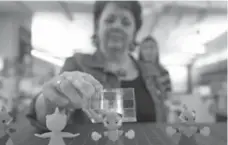  ?? CHRIS SO/TORONTO STAR ?? Denise Wilson, senior director of quality assurance for the Marketing Store, checks a prototype of Pokemon character that will go into a Happy Meal.