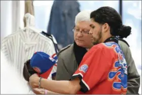  ?? ERIC BONZAR — THE MORNING JOURNAL ?? Twenty-year-old Reinaldo Contreras III helps customer Jim Woltman, of Lorain, pick out a vintage hat for his son, Feb. 16, during Contreras’ RICHES 2 RELICS pop up shop held at Jevon Terance Boutique, 615 Broadway Ave. Contreras will also be on hand to...