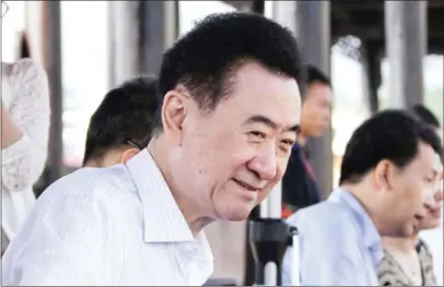  ?? AFP/STRINGER ?? Chairman of China’s Wanda Group Wang Jianlin attends a welcome ceremony in Danzhai, Guizhou province, on July 3. The conglomera­te said yesterday it will sell dozens of holdings to cut its debt.