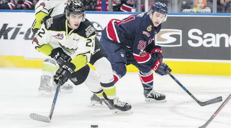  ?? SHAUGHN BUTTS ?? Matthew Robertson of the Oil Kings works the puck on his backhand while skating away from Nick Henry of the Pats on Sunday at Rogers Place.