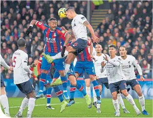  ??  ?? Liverpool’s Dejan Lovren heads clear from Jordan Ayew