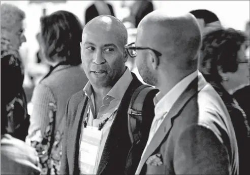  ?? TERRENCE ANTONIO JAMES/CHICAGO TRIBUNE ?? Former Massachuse­tts Gov. Deval Patrick, left, attends the 2019 Obama Foundation Summit at the Kaplan Institute at the Illinois Institute of Technology in Chicago.
