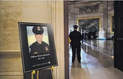  ?? Brendan Smialowski The Associated Press file ?? A placard is displayed with an image of the late U.S. Capitol Police officer Brian Sicknick on Feb. 2. Sicknick suffered a stroke and died from natural causes, the Washington, D.C., medical examiner’s office ruled Monday.