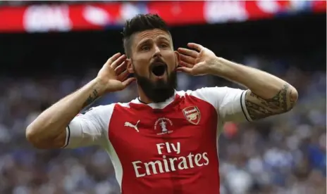  ?? KIRSTY WIGGLESWOR­TH/THE ASSOCIATED PRESS ?? Arsenal’s Olivier Giroud celebrates after Aaron Ramsey scored their side’s second goal. Arsenal salvaged a disappoint­ing season by beating Chelsea.