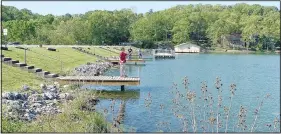  ?? (NWA Democrat-Gazette/Sally Carroll) ?? Scott Garrett, along with his stepfather and two sons, enjoy some fishing on Lake Avalon.