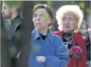  ?? AFP ?? Local residents react as they look at the body of a woman who died as a result of a downed missile explosion outside a polyclinic during the Russian attack on the Ukrainian capital of Kyiv yesterday.