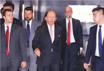  ?? Reuters ?? Wilbur Ross leaves a hotel ahead of trade talks with Chinese officials in Beijing yesterday. The US and China have threatened tit-for-tat tariffs on goods worth up to $150 billion each.