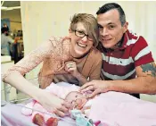  ??  ?? Naomi Findlay and Dean Wilkins, left, were told that a terminatio­n was the only option after a scan, bottom, showed their baby Vanellope, right, had ectopia cordis