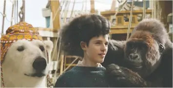  ?? — UNIVERSAL PICTURES ?? Actor Harry Collett shares the screen with a talking polar bear (John Cena) and gorilla (Rami Malek) in the new movie Dolittle.