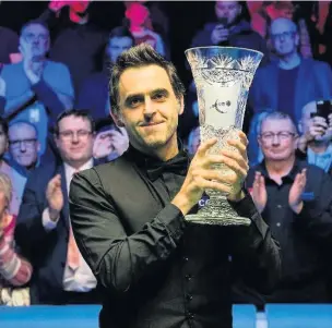  ??  ?? Ronnie O’Sullivan lifts the trophy at the event in Preston last year