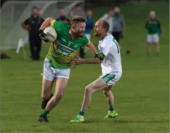  ??  ?? Kilcoole’s James Scullion skips past Donard’s Nicky Donovan in Ballinakil­l. Photo: Paul Messitt