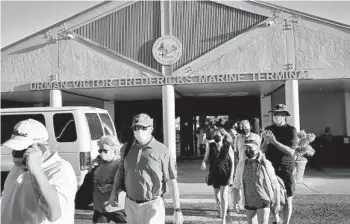  ?? GABBY JONES/THE NEW YORK TIMES ?? People exit from a ferry terminal last month in Saint Thomas in the U.S. Virgin Islands.