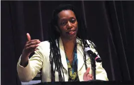  ?? Photo by Ernest A. Brown ?? Rhode Island Department of Health Director Dr. Nicole Alexander-Scott answers questions while seated at a table, new to the COVID-19 briefing format, at Veterans Memorial Auditorium Thursday.