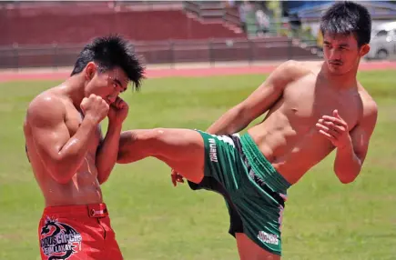  ?? Photo by JJ Landingin ?? DAILY GRIND. MMA fighters Joshua Pacio and Jeremy Pacatiw sweat it out at the Baguio Athletic Bowl as they gear up for their respective bouts.