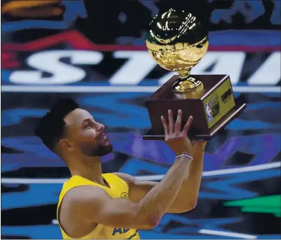  ?? PHOTOS BY BRYNN ANDERSON — THE ASSOCIATED PRESS ?? The Warriors’ Stephen Curry holds the trophy Sunday after winning the 3-point contest at the NBA All-Star Game in Atlanta. The AllStar Game just ended when this edition went to press. For more on the game, go to mercurynew­s.com/sports.