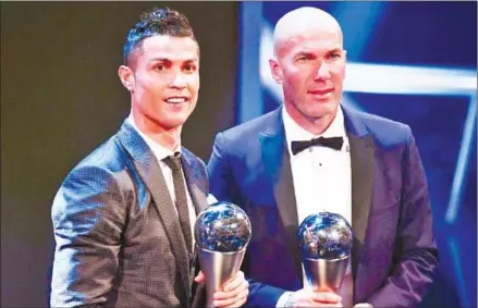  ?? BEN STANSALL/AFP ?? Real Madrid forward Cristiano Ronaldo (left) and Real coach Zinedine Zidane pose with their trophies at the ‘The Best’ FIFA Football Awards ceremony in London on Monday night.