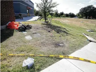  ?? Photos by Amanda McCoy / Associated Press ?? A parachute and other items remain in the area where one pilot landed after ejecting from a military training jet before it crashed Sunday in a neighborho­od near Fort Worth.