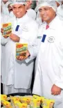  ??  ?? Minister of Economic Developmen­t Basil Rajapaksa with a freshly produced packet of Maggi Ricey, Nestlé Lanka s most indig enous Maggi noodles product in Sri Lanka, alongside Nandu Nandkishor­e, Executive Vice President of Nestlé worldwide (Nestlé S.A.)...