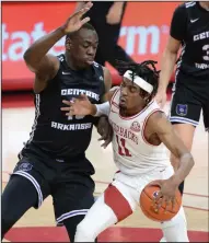  ?? (NWA Democrat-Gazette/Andy Shupe) ?? Arkansas guard Jalen Tate ( 11) drives to the basket as he is pressured by Central Arkansas forward Eddy Kayouloud during Saturday’s 100-75 victory for the Razorbacks. With Arkansas not scheduled to play until Sunday against Oral Roberts, Tate said the team will use the break to study film and make adjustment­s.