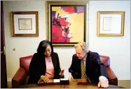  ?? AP PHOTO BY DAVID GOLDMAN ?? Sharonda Fields, left, who said she was abused while working at a Georgia restaurant last year, talks with her attorney Brad Dozier in his office in Atlanta Dec. 4.
