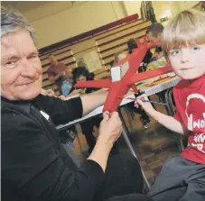  ??  ?? Finlay Carter, seven, is pictured with his grandad Joe Newby putting the finishing touches to his model plane in 2013.