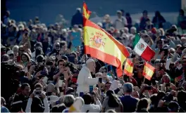  ?? — AP ?? Pope Francis passes by as Spanish flags wave in the crowd during his weekly general audience in St. Peter’s Square at the Vatican on Wednesday.