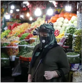  ?? (AP/Ebrahim Noroozi) ?? A woman ventures through the Tajrish traditiona­l Iranian bazaar Thursday in northern Tehran. Eight months after the coronaviru­s pandemic first stormed Iran, authoritie­s appear just as helpless to prevent its spread.