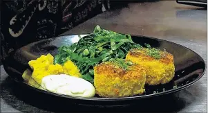  ?? NIGEL ARMSTRONG/THE GUARDIAN ?? Tempeh “crab” cakes with sugar and gluten free mustard pickles, egg-free remoulade, and sauteed collard greens are prepared by chef Sarah Forrester-Wendt at her Charlottet­own restaurant My Plum, My Duck.