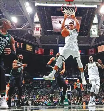 ?? AP ?? Milwaukee Bucks’ Giannis Antetokoun­mpo dunks during the first half of Game 4 of an NBA first-round play-off series against the Boston Celtics on Sunday.