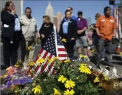  ?? JOHN LOCHER, THE ASSOCIATED PRESS ?? People pause at a memorial for the victims of a mass shooting in Las Vegas, Wednesday.