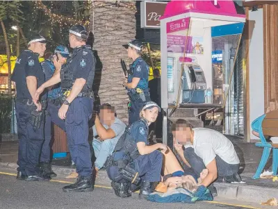  ??  ?? A woman lies injured in a Surfers Paradise street after allegedly being attacked by a man at 2am on Sunday.