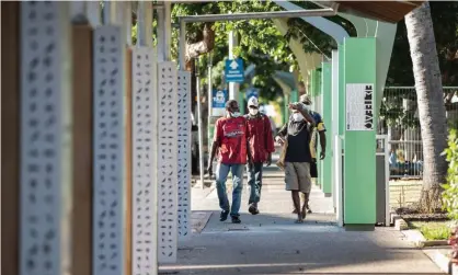  ?? Photograph: Helen Orr/Getty Images ?? People wear masks in Smith Street, Darwin. Aboriginal organisati­ons have called for more help for people sleeping rough around town centres who may be at risk of Covid-19.