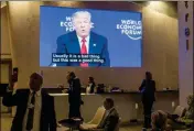 ?? GIAN EHRENZELLE­R/KEYSTONE VIA AP ?? U.S PRESIDENT DONALD TRUMP’S speech is transmitte­d on a screen on the last day of the annual meeting of the World Economic Forum, WEF, in Davos, Switzerlan­d, on Friday.