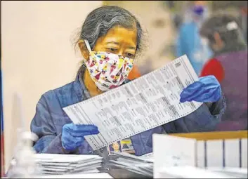  ?? Marcio Jose Sanchez The Associated Press ?? An election worker sorts mail-in ballots at the Multnomah County DuniwayLov­ejoy Elections Building on Monday in Portland, Ore.