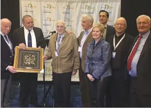  ??  ?? HOLOCAUST SURVIVOR Baruch Shuv receives a Limmud FSU award on Thursday night for his resistance during the war from Defense Minister Avigdor Liberman (second left) as other supporters and members of the organizati­on look on.