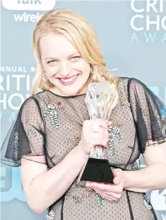  ?? — Reuters file photo ?? Moss poses with her Best Actress in a Drama Series award for ‘The Handmaid’s Tale’ during the 23rd Critics’ Choice Awards in January.