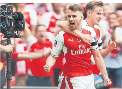  ?? Picture / AP ?? Aaron Ramsey, who scored Arsenal’s winning goal against Chelsea, says he hopes Arsene Wenger stays.