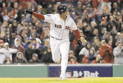  ?? DAVID J. PHILLIP/ASSOCIATED PRESS ?? The Red Sox’s Rafael Devers hits an RBI single against the Dodgers during the fifth inning of Game 1 of the World Series on Tuesday night, which ended too late for this edition. Boston led 5-3 in the sixth inning. Coverage online at baltimores­un.com/sports