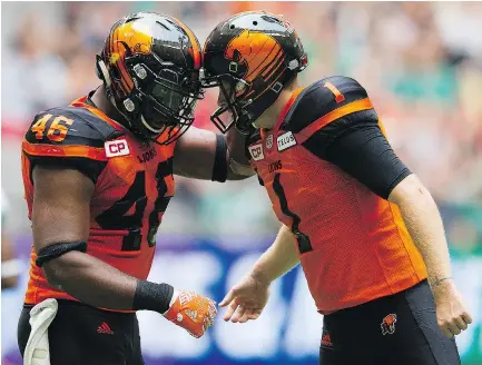  ?? GERRY KAHRMANN/PNG FILES ?? Rolly Lumbala bumps helmets with Ty Long after a successful field goal against the Saskatchew­an Roughrider­s at B.C. Place in August.