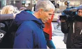  ?? CJ Gunther EPA/Shuttersto­ck ?? WILLIAM “RICK” SINGER leaves court in Boston. Parents paid him to help their children cheat on exams and to falsify athletic records, prosecutor­s said.