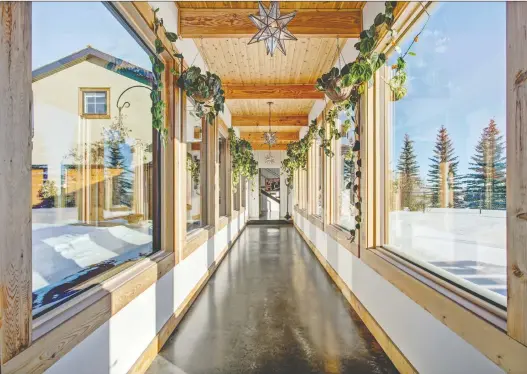  ?? PHOTOS: WOOLRICH GROUP ?? An indoor breezeway with tongue and groove pine connects a standalone garage to the main house as part of redesign in a Bearspaw home by Woolrich Group.