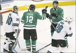  ?? MICHAEL AINSWORTH — THE ASSOCIATED PRESS ?? Dallas players Radek Faksa (12) and Tyler Pitlick celebrate Pitlick’s third-period goal in front of Sharks goalie Aaron Dell and forward Timo Meier during Sunday’s game.