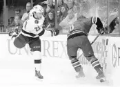  ?? GERRY BROOME/ASSOCIATED PRESS ?? Tampa Bay’s Brayden Point (21) and Carolina’s Klas Dahlbeck chase the puck during the first period Saturday.