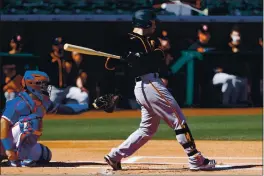  ?? CHRISTIAN PETERSEN — GETTY IMAGES ?? The San Francisco Giants’ Tommy La Stella bats against the Texas Rangers during the first inning of a spring training game on Monday in Surprise, Ariz.