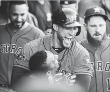  ?? GREGORY SHAMUS GETTY IMAGES ?? George Springer of the Houston Astros celebrates with Tony Kemp after hitting a homer against the Indians in Cleveland on Monday.