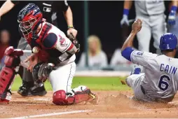  ?? (Reuters) ?? CLEVELAND INDIANS catcher Roberto Perez (left) can’t handle the ball as Kansas City Royals baserunner Lorenzo Cain scores during the fifth inning of the Royals’ 4-3 road victory on Friday night, a result that spelled the end of the Indians’ record...