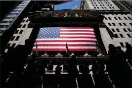  ?? JULIA NIKHINSON — THE ASSOCIATED PRESS ?? People walk past the New York Stock Exchange on June 29.