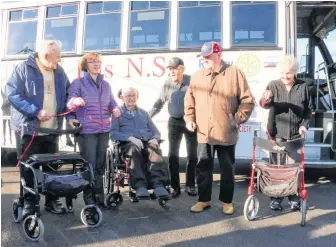  ??  ?? Melodee Boyd (second from left) and her brother Bob Boyd (second from right), helped cut a ribbon in front of the Windsor Senior Citizen Bus Society’s newest edition. The bus has been named in honour of their father, Grant Boyd, who was instrument­al in getting the bus service started decades prior